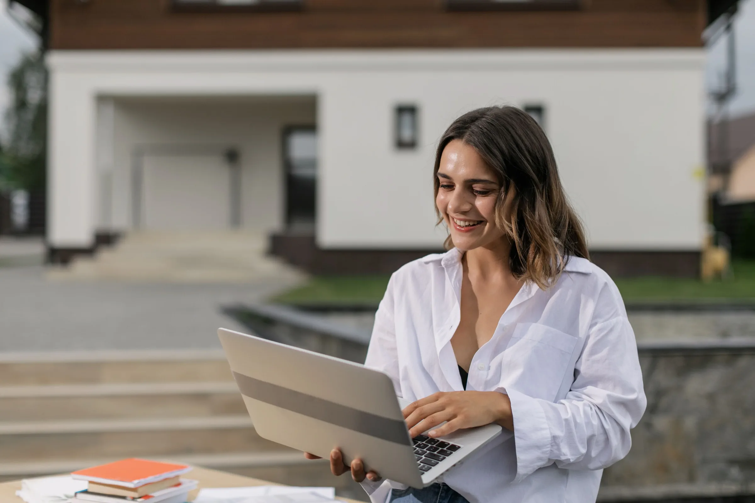 Confident professional woman using a laptop for IIQE exam preparation success